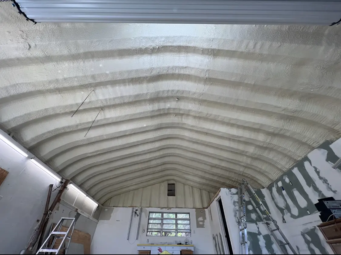 Spray polyurethane foam applied to the underside of a metal roof deck in Bend